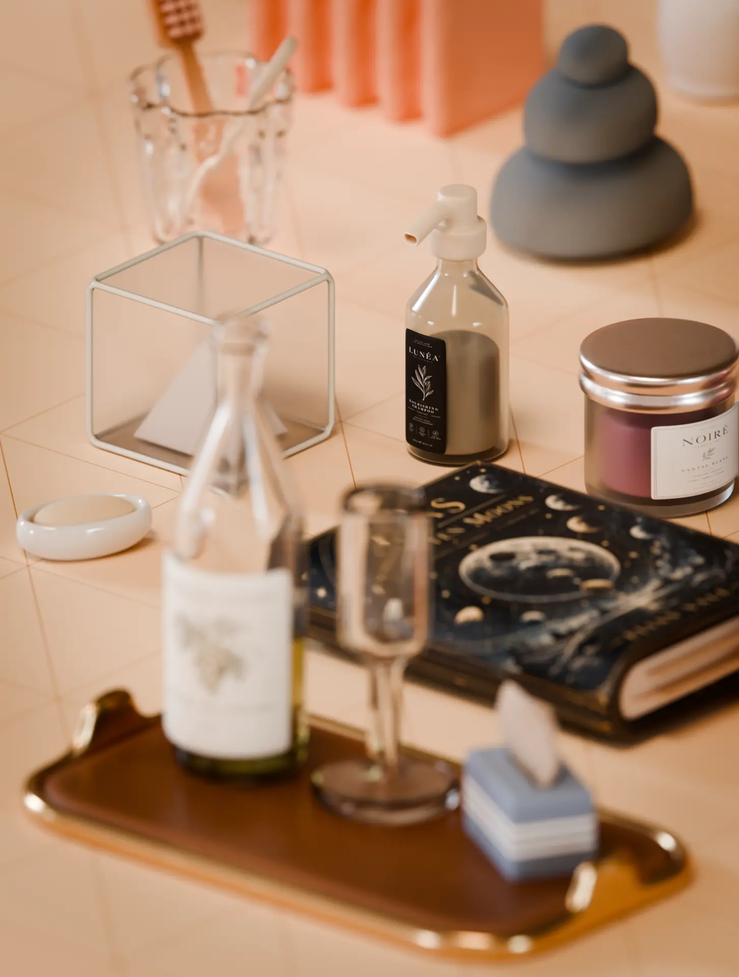 Vanity corner with a shampoo bottle, moon-phases book, candle jars and a tray with wine
